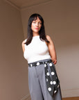 Handmade silk skinny scarf styled as a belt on a woman, black with white polka dots, by nessi, an Australian independent fashion label