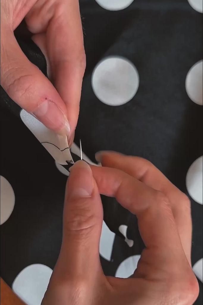 A hand-rolled hem finish on silk scarf by Australian brand nessi